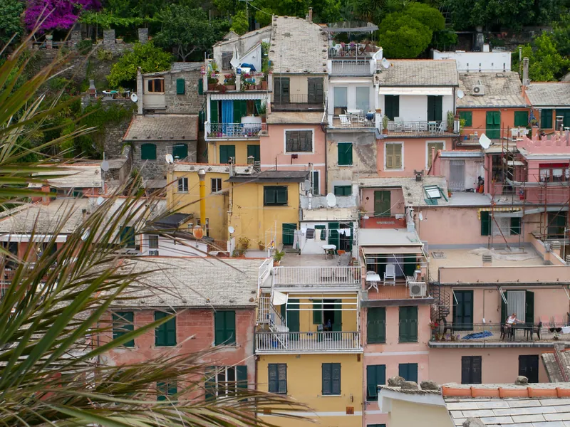 Pastel terraced houses stacked above the coast in Cinque Terre, Italy